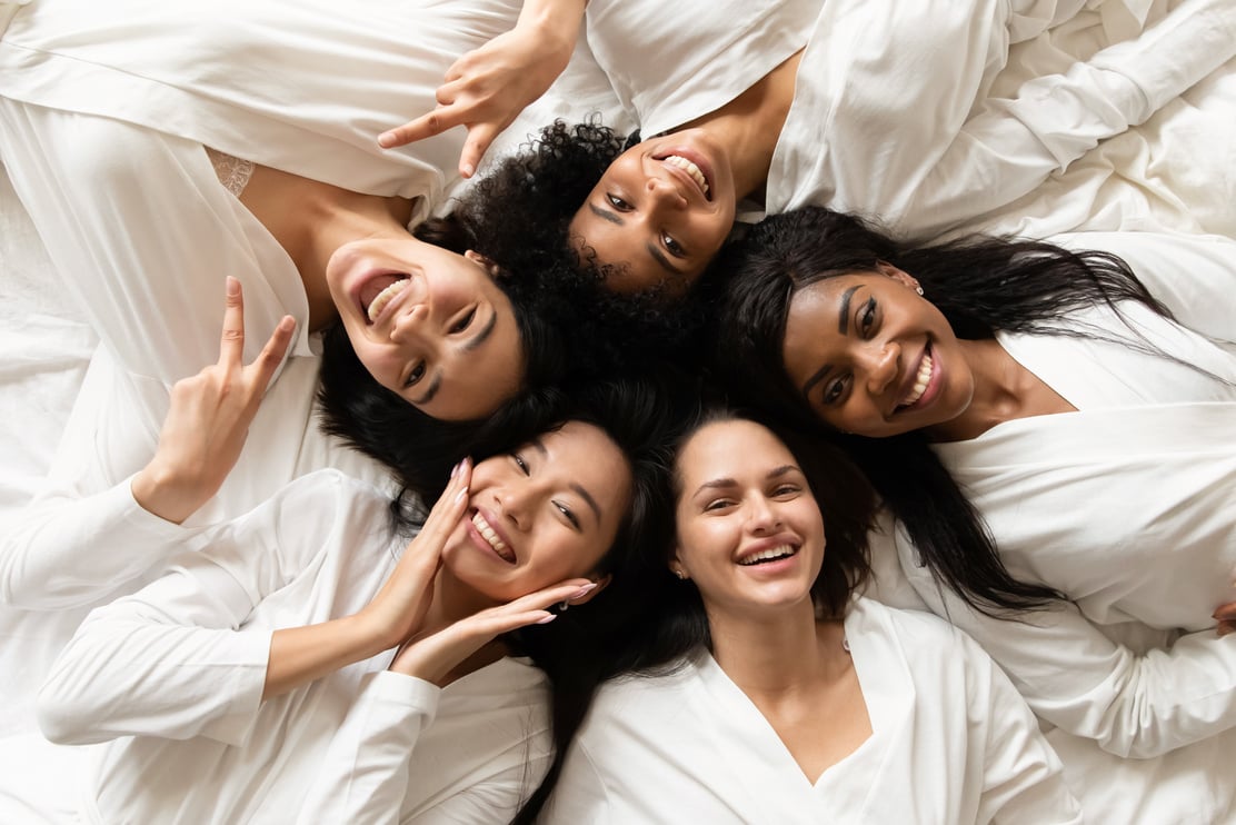 Diverse women lying in bed feels happy after spa procedures